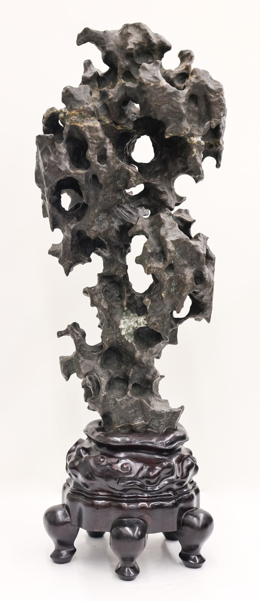 Chinese Stone Scholar's Rock on Stand: Chinese Stone Scholar's Rock on Stand 27''x11''. Dramatic tall grey stone on a fitted rosewood stand. Excellent condition. It weighs 35 pounds.