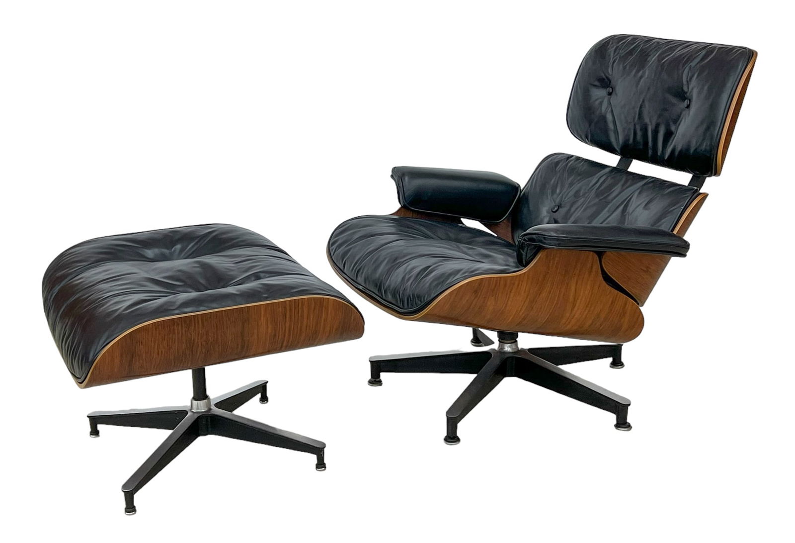 Eames: Herman Miller Lounge Chair and Ottoman: Charles & Ray Eames for Herman Miller Rosewood Lounge Chair & Ottoman. Second generation 670 and 671 black leather set with rosewood shells. Chair measures 32''x33''x32'' and ottoman 16''x26''x22''. O