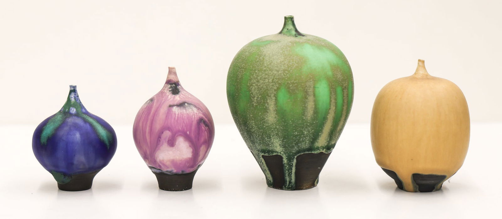 Rose Cabat: Collection of Four Feelies: Rose Cabat (1914-2015 American) ''Collection of Four Feelies'' Glazed Stoneware 2.5'' to 4.25''. Incised signature on bottom. Slight roughness to top edge of smallest blue vessel. Otherwise excellent