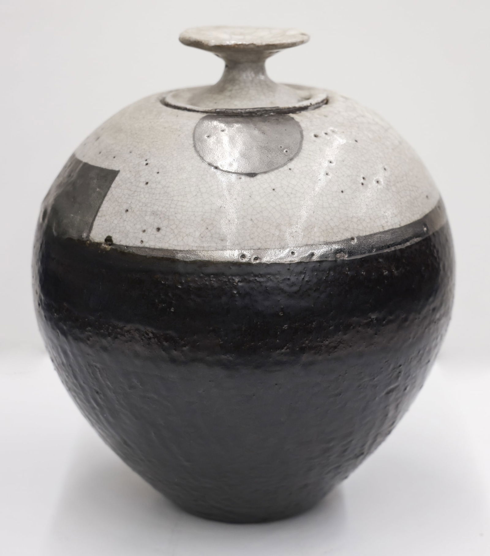 Robert Sperry White Crackle Jar 1984 Stoneware: Robert Sperry (1927-1998 Washington) ''White Crackle Jar'' 1984 Glazed Stoneware 12''x11''. Silver luster and black glazes against his typical white crackle. Incised signature on bottom. Excellent con