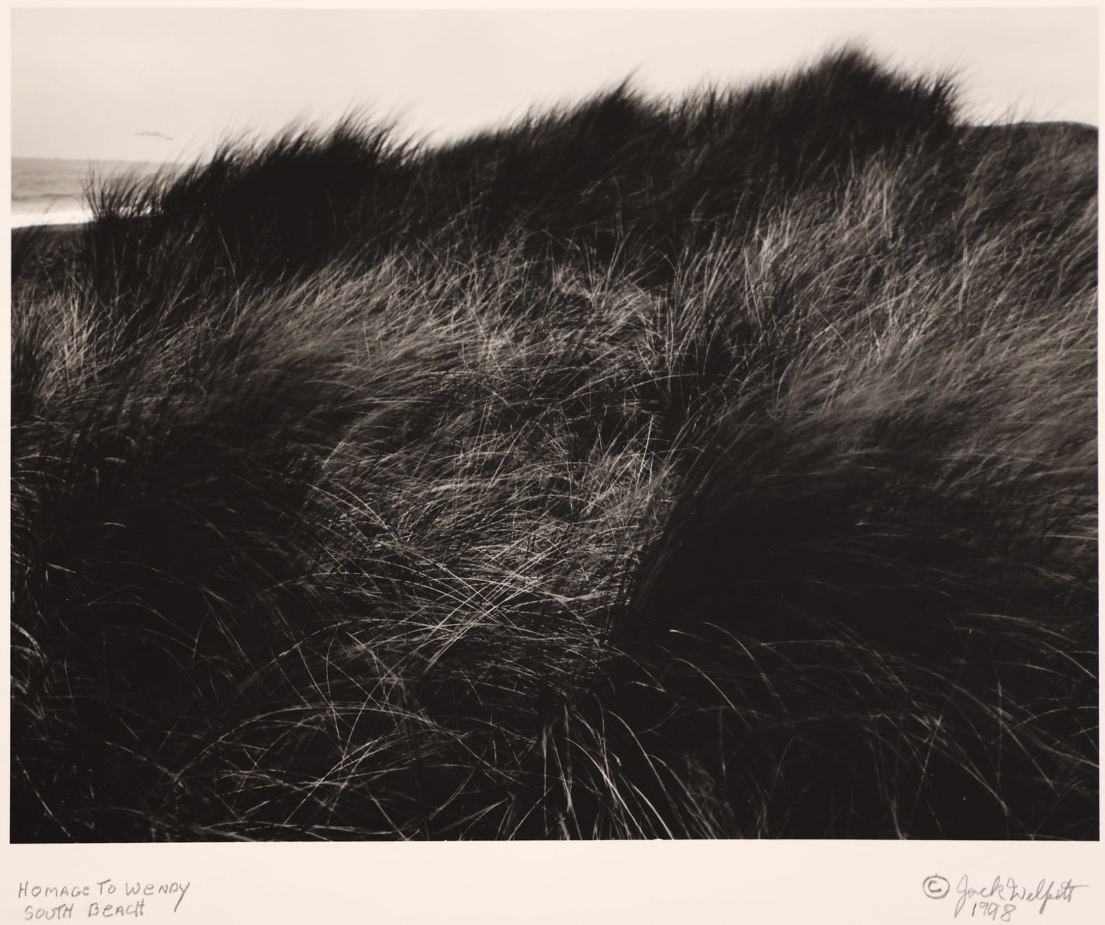 Jack Welpott ''Homage to Wendy, South Beach'' 1998: Jack Welpott (1923-2007 American) ''Homage to Wendy, South Beach'' 1998 Silver Gelatin Print 9''x12'' Image. Pencil signed and titled lower margin. Loosely mounted into matting 16''x20''. Excellent co