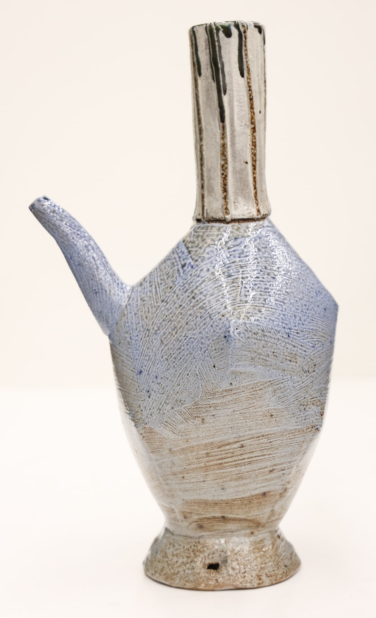 John Gill Wine Ewer 1976 Stoneware: John Gill (b.1949 New York) Wine Ewer 1976 Stoneware 12''x7''. Slab thrown altered form with blue and white salt fired glazes. Signed and dated on bottom. Two slight firing cracks to base, original to