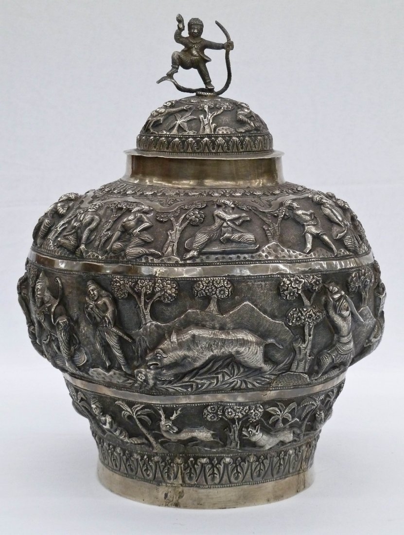 Antique Burmese Repousse Heavy Silver Covered Balus: Antique Burmese Repousse Heavy Silver Covered Baluster Jar 12''x9.5''. Depicts seated and dancing male/female figures within landscapes. Figural finial with man on snake. Lion and elephant hunt scenes