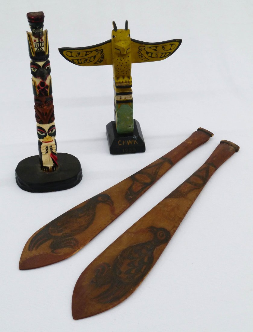 Group Northwest Coast Indian Carved Totem Poles an: Group Northwest Coast Indian Carved Totem Poles and Paddles. Pair of red and black painted bird oars 12'', painted carved whale bone Chief eagle Raven Owl Totem 7.5'', and Coqualeetza Indian School 19