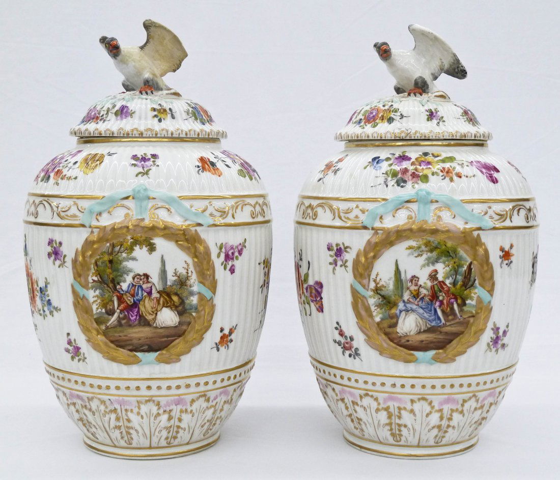 Pair KPM Porcelain Covered Floral Urns with Eagle: Pair KPM Porcelain Covered Floral Urns with Eagle Finials 12"x7" Each. Each side has a hand painted courting scene within a wreath. Drilled bottom and lid. Old repair to eagle wings. 19th century.