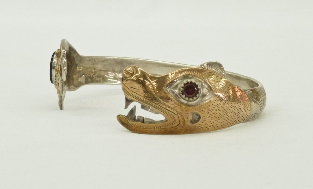 Larry Taranoff Silver and Gold Overlay Northwest Coast: Larry Taranoff Bear Head and Claw Silver with Gold Overlay Northwest Coast Native Style Cuff Bracelet 3". Embellished with semi precious stones and gold nuggets. Signed in script, Larry Taranoff Sitka