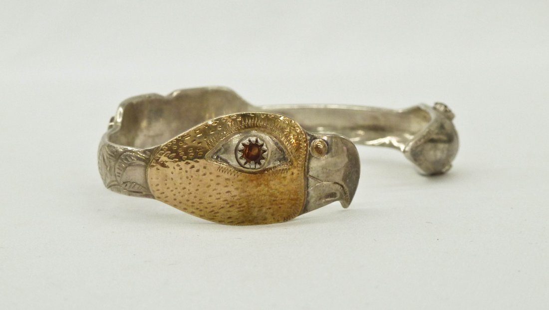 Larry Taranoff Eagle and Bird Silver with Gold Overlay: Larry Taranoff Eagle and Bird Silver with Gold Overlay Northwest Coast Native Style Cuff Bracelet 2.75". Embellished with semi precious stones and gold nuggets. Signed in script, Larry Taranoff Sitka 