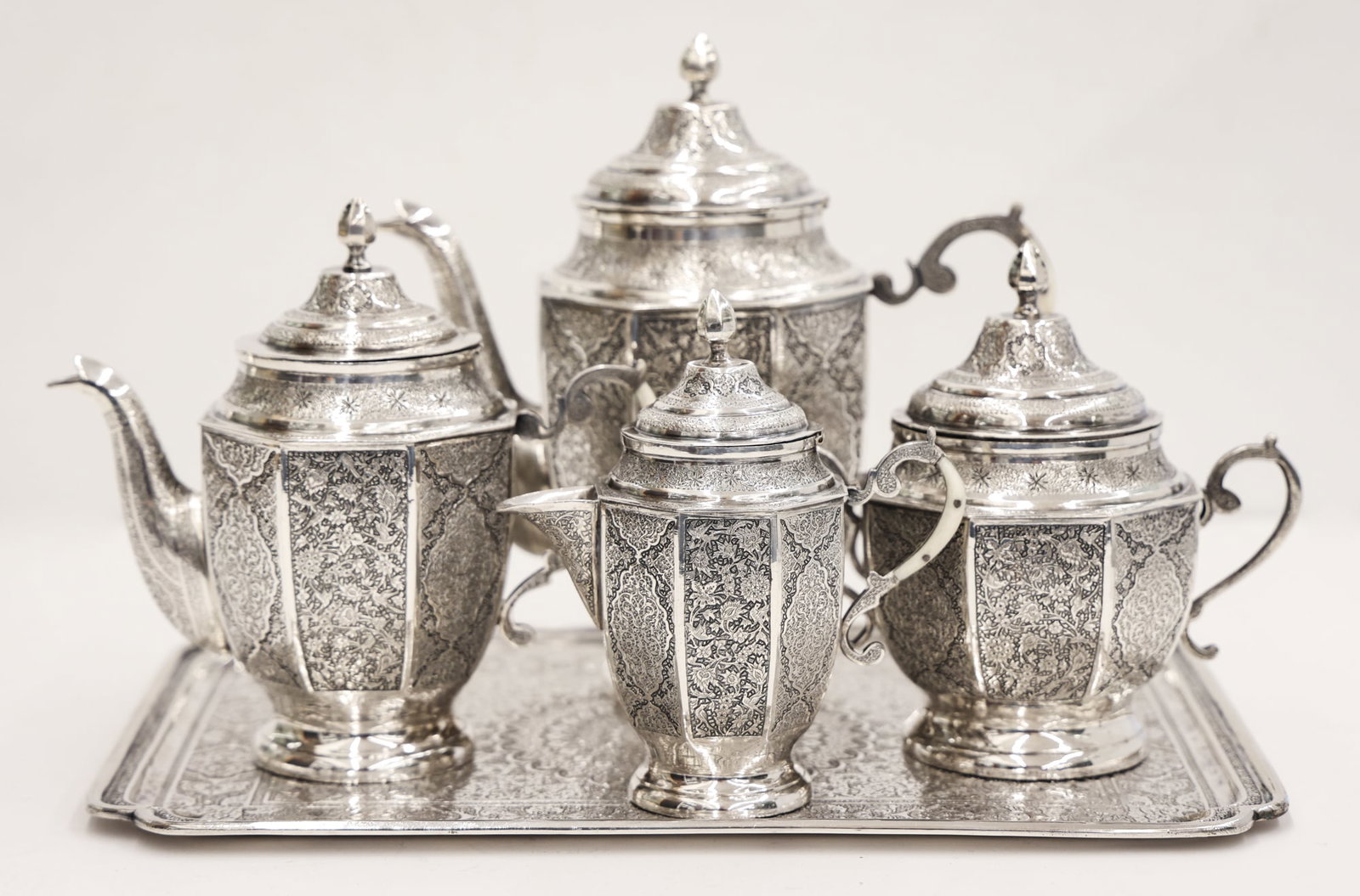 5pc Ornate Persian Vartan 84 Silver Tea Service: 5pc Ornate Persian Vartan 84 Silver Tea Service 9''x13.5''. Intricately hand chased scrolling floral motifs with applied bone handles. Includes two sizes of teapot, sugar creamer, and serving tray. Ea
