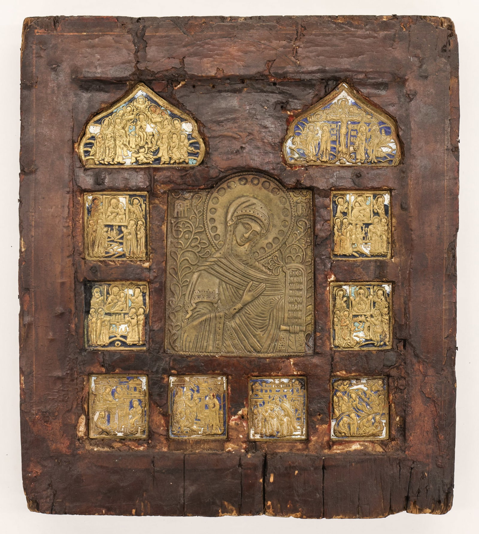 Antique Russian Mother of God of the Passion Icon: Antique Russian Mother of God of the Passion Icon 12''x10.5''. Wood inset with eleven brass plaques, some with enameling. Scattered edge loss and wear from age. 19th century.