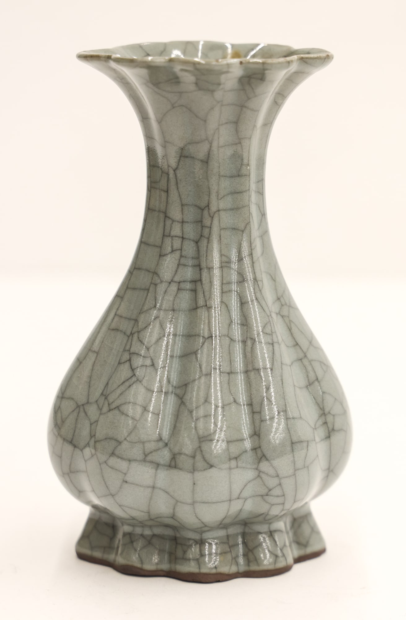 Old Chinese Guan Crackle Scalloped Vase: Old Chinese Guan Crackle Scalloped Vase 6''x3.5''. Slight hairline crack to top edge. Overall excellent condition, examined under blacklight. Ceramic was wrapped in newspapers from the 1990's and acqu