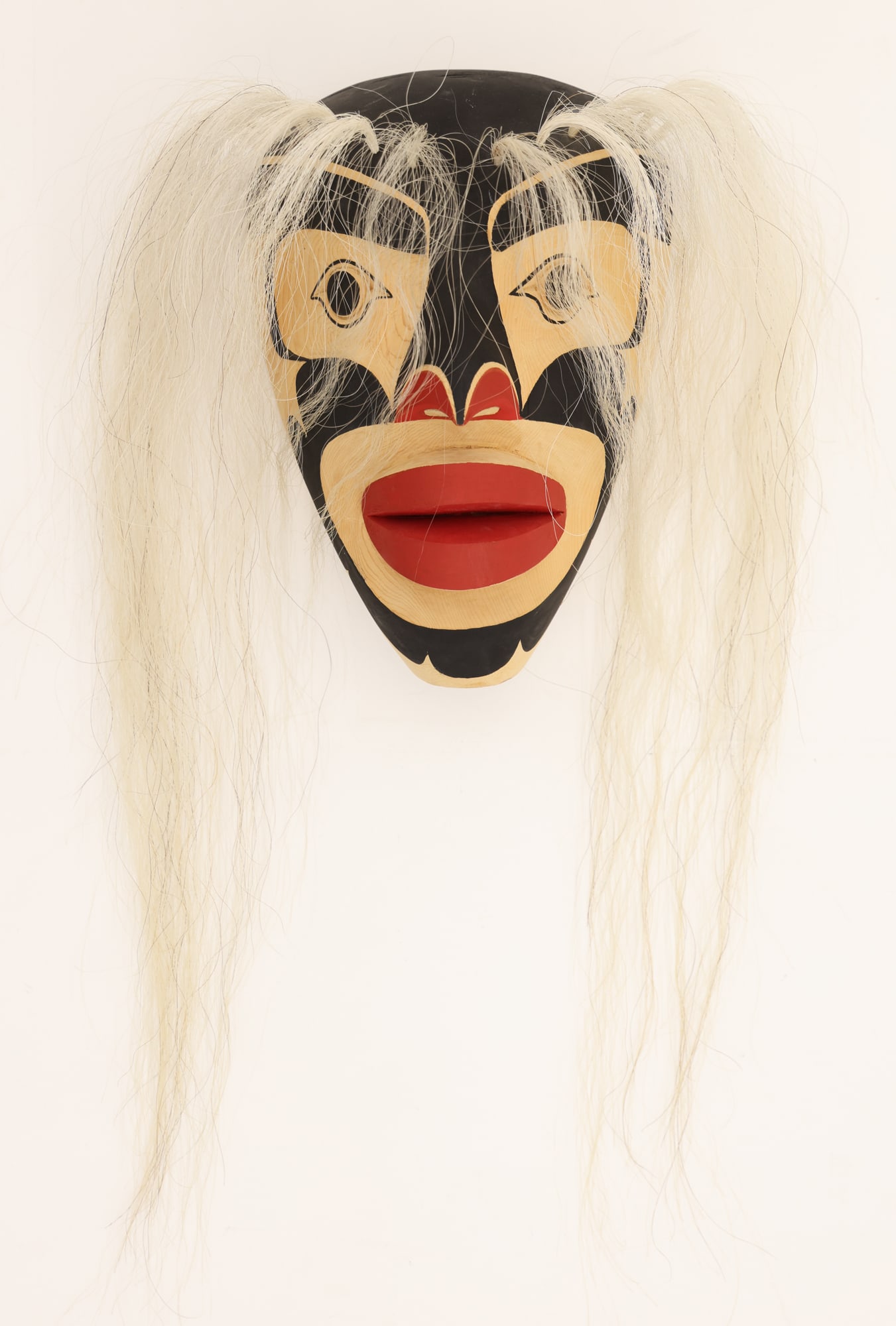 James Speck Sr. "Woman Mask" 2001 Painted Cedar: James Speck Sr. (20/21st Cent. Kwakwaka'wakw) "Woman Mask" 2001 Carved and Painted Cedar 12"x8". Polychrome painted formline motifs with applied horse hair 24" long. Unsigned with Artist's business ca