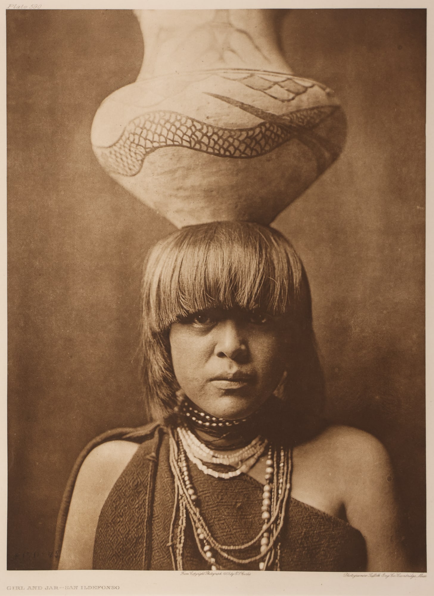 Edward Curtis "Girl and Jar, San Ildefonso" 1905 Photogravure: Edward Curtis (1868-1952 American) "Girl and Jar, San Ildefonso" (Plate 590) 1905 Photogravure on Van Gelder 15.5"x11.5" Image. Sheet size 21.75"x17.75" with full margins. Modern framing 26.5"x22.5".