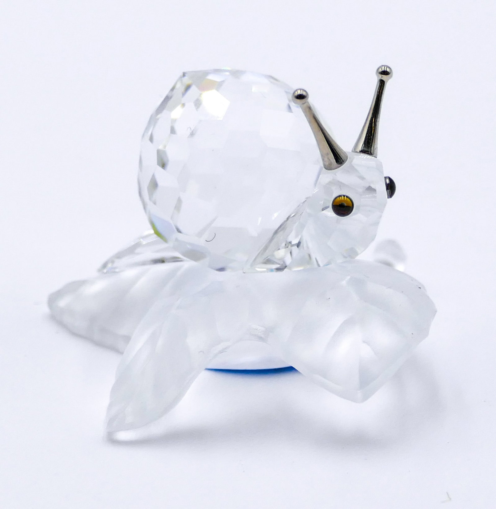 Swarovski Crystal "Snail on Vine Leaf" 1": Swarovski Crystal "Snail on Vine Leaf" 1". Catalog #7615NR005. Includes original box.