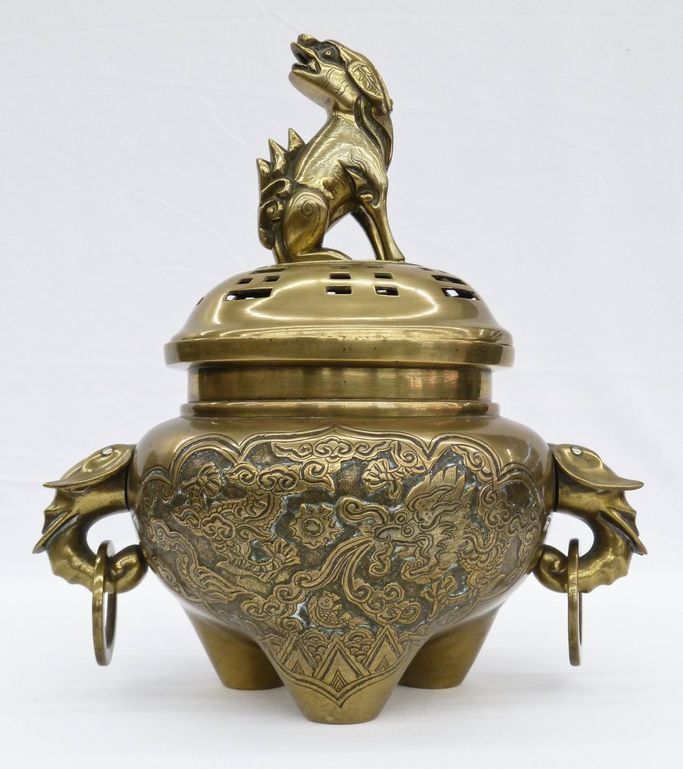 Antique Chinese Worked Bronze Covered Foo Dog Censor 11: Antique Chinese Worked Bronze Covered Foo Dog Censor 11.75''x10.5''. Figural foo lion finial and elephant head handles. The front and back have worked dragon lion scenic. Polished with old soldered re