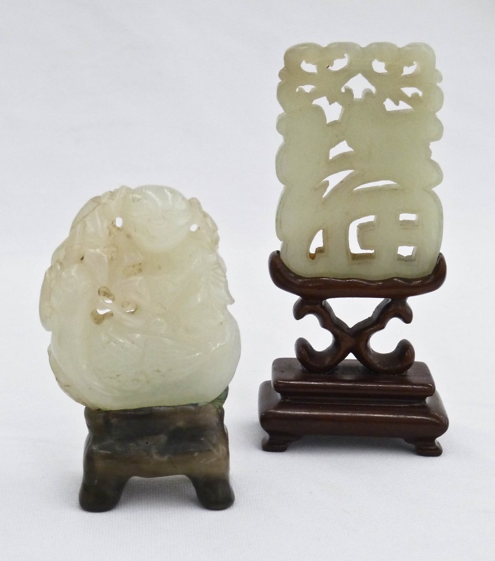 (2) Chinese Carved Celadon Jade Pendants on Stand. Pier: (2) Chinese Carved Celadon Jade Pendants on Stand. Pierced carved boy riding duck 1.75'' and pierced character pendant 2'' on fitted wood stand.
