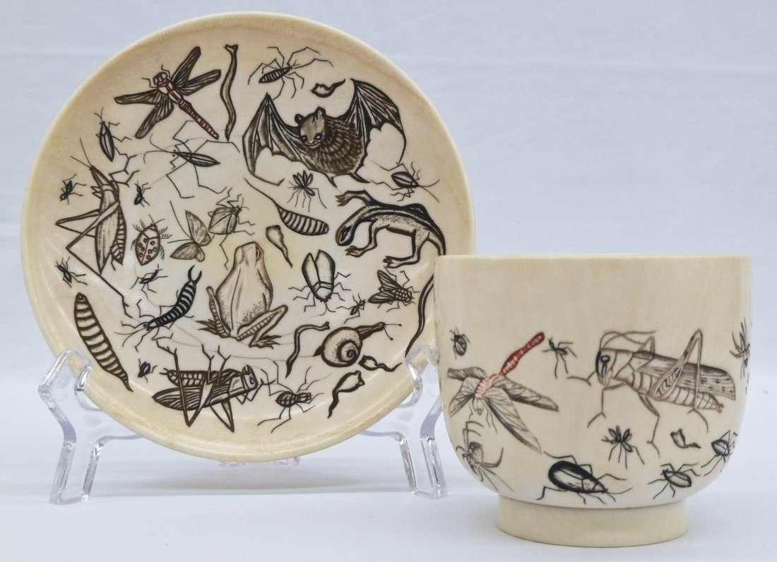 Meiji Japanese Carved Ivory Cup & Saucer with Insects, : Meiji Japanese Carved Ivory Cup & Saucer with Insects, Lizards, Bats, and Snails. Cup measures 2.5''x2.75'' and is missing handle. Saucer is 4.75'' in diameter. Weighing 203 grams.