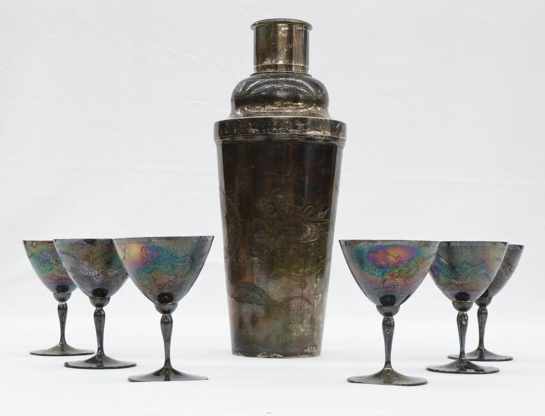 Chinese 900 Export Silver Dragon Cocktail Set Including: Chinese 900 Export Silver Dragon Cocktail Set Including Shaker & (6) Liquor Stems. Shaker measures 9.25'' and each cup 3''. Each piece depicts a dragon swimming in the clouds. It weighs a total of 21.