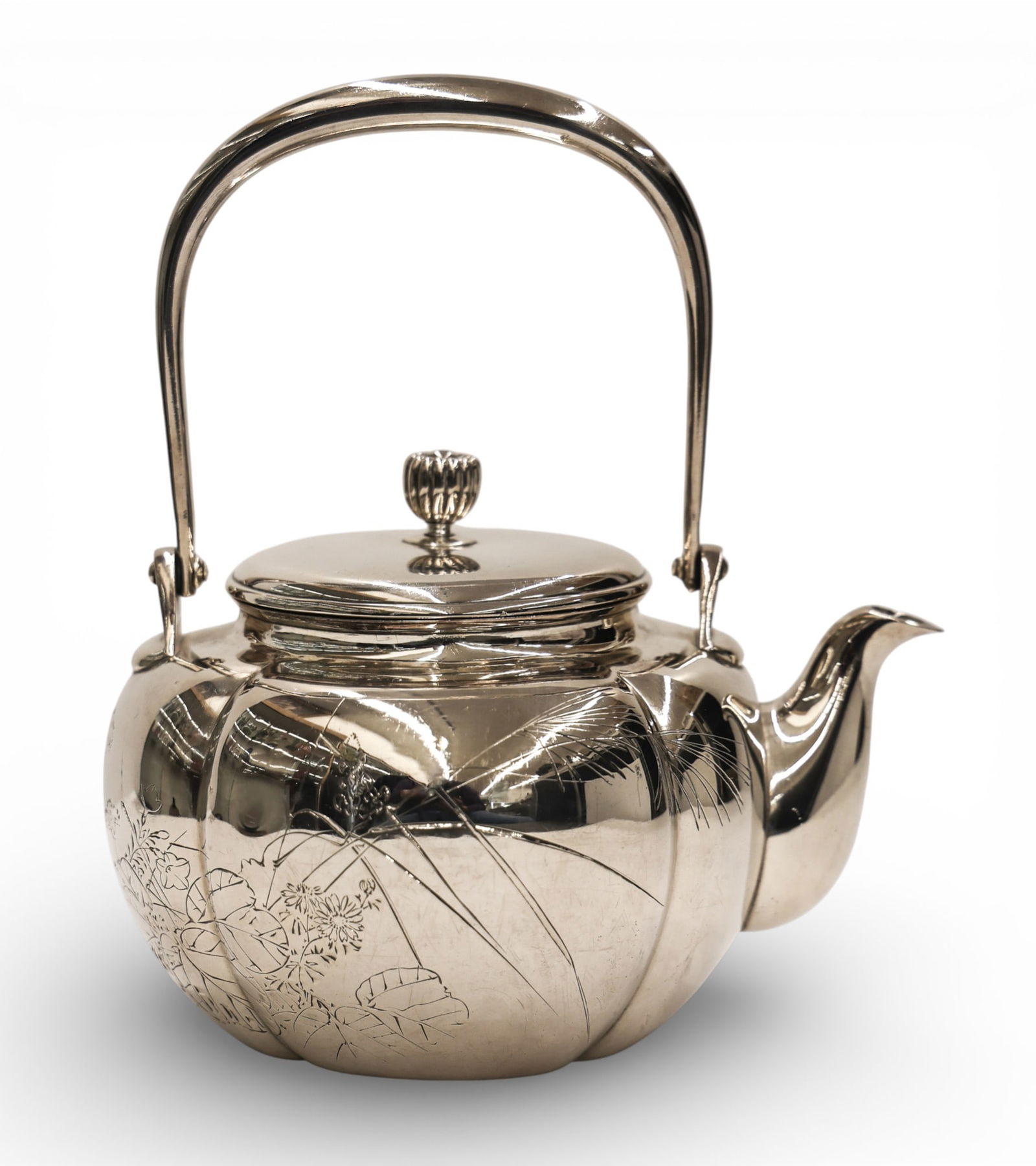 Signed Japanese Sterling Teapot with Floral Motif: Signed Japanese Sterling Teapot with Floral Motif 7"x6". Hand engraved floral motif with butterflies. Signed by the artisan under spout. Jungin silver marks on bottom. One small dent on the side of th