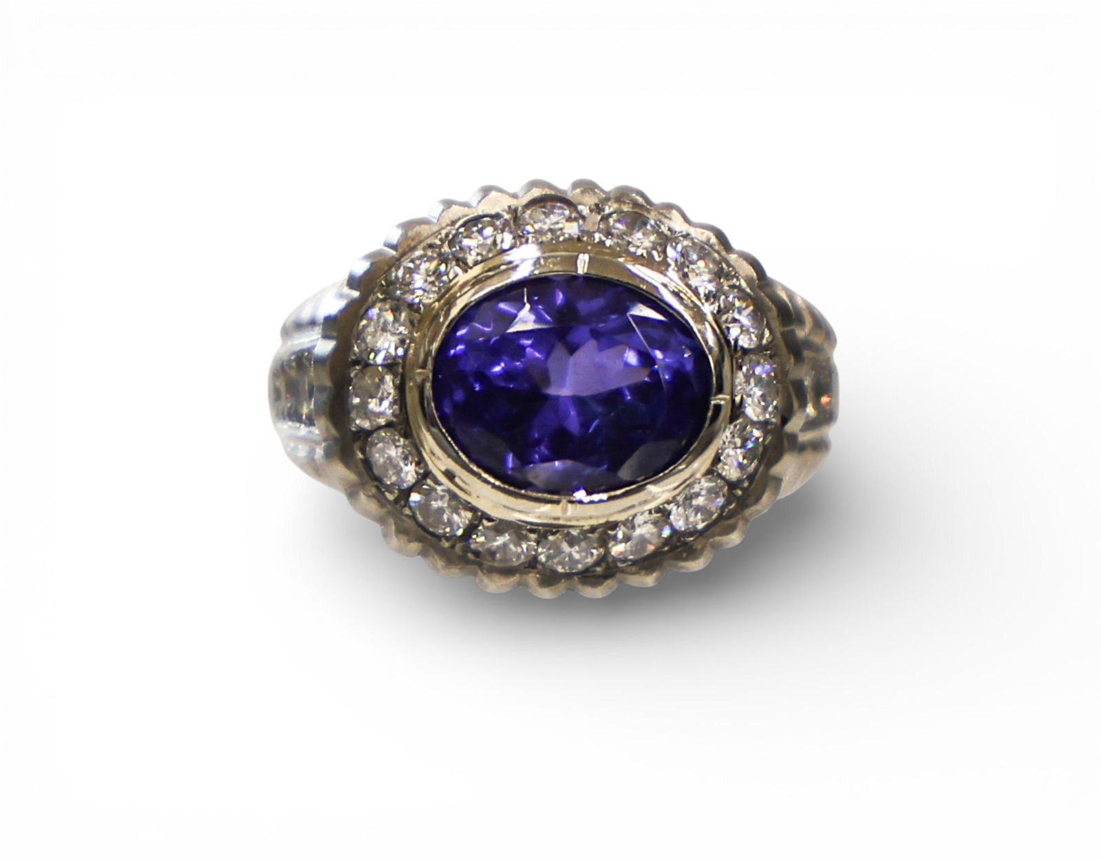 Ladies Tanzanite and Diamond 14k White Gold Ring Size 8.5: Ladies Tanzanite and Diamond 14k White Gold Ring Size 8.5. Includes one transparent medium-dark bluish-violet 4.69ct tanzanite zoisite measuring 11x9x6.5mm. It is surrounded by (24) round brilliant cu