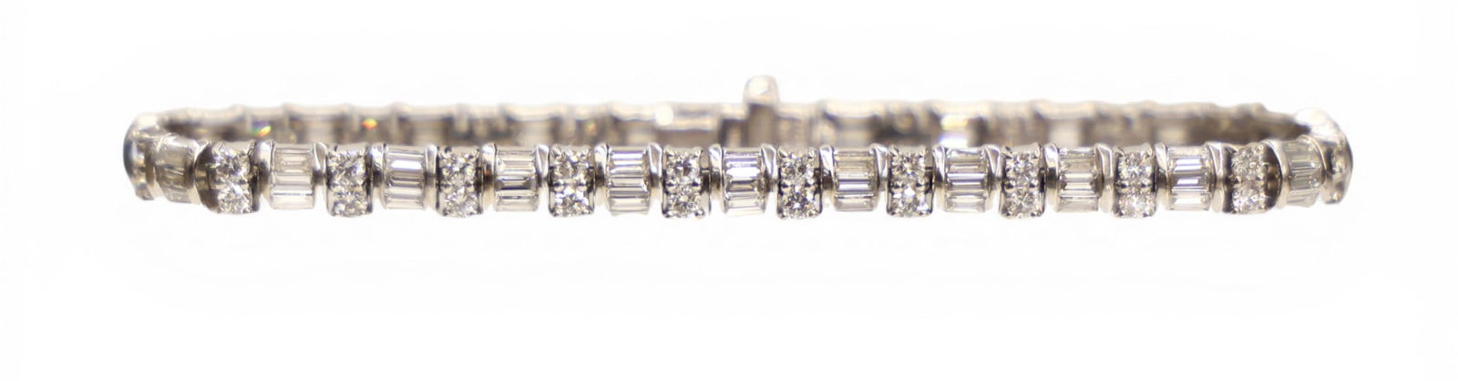 Ladies 4.7ctw Diamond 18k White Gold Tennis Bracelet 7": Ladies 4.7ctw Diamond 18k White Gold Tennis Bracelet 7". Includes (48) round brilliant and (72) straight baguette cut diamonds of average color E-F and clarity VS-SI. Marked "Coast 18K" and is 5.1mm t