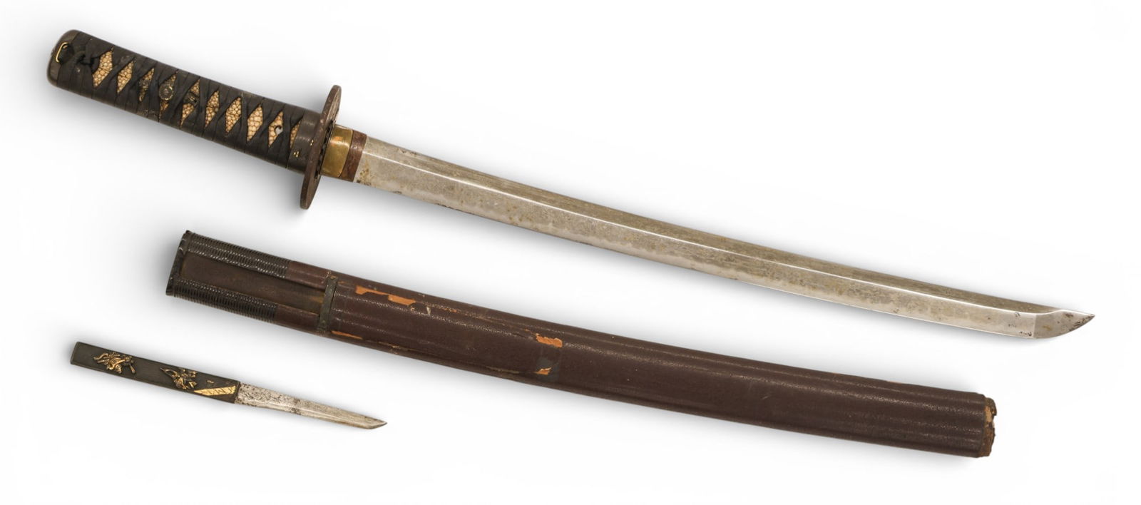 Antique Japanese Samurai Wakazashi Short Sword with Kozuka: Antique Japanese Samurai Wakazashi Short Sword with Kozuka 25.5". Lacquered wood scabbard with bronze menuki, fuchi and kashira. Inlaid iron tsuba. Blade is unsigned and measures 22.5" to tang. Some c