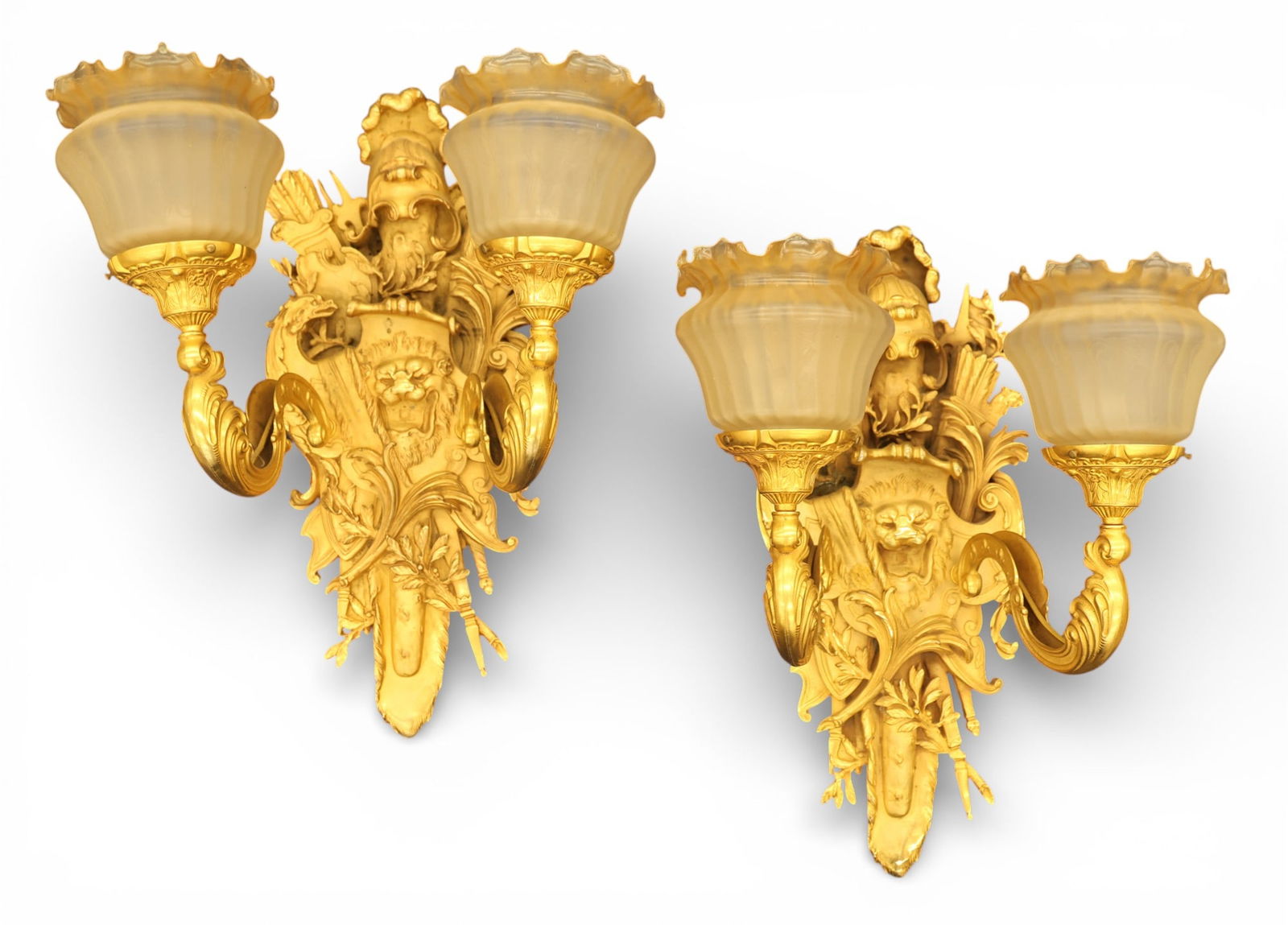 Impressive Pair French Empire Dore Bronze Double Light Sconces: Impressive Pair French Empire Dore Bronze Double Light Sconces 27"x21"x15". Heraldic motif with lion head, crossed bows and swords, and helmet finial. Etched glass ruffled shades 6.5"x7.5". Each has