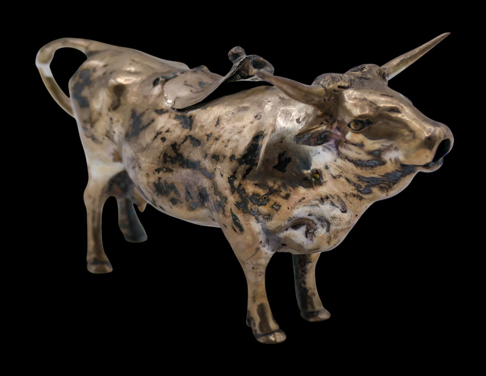Israel Freeman & Son German Sterling Cow Miniature Creamer: Israel Freeman & Son German Sterling Cow Miniature Creamer 3"x5". Figural bull form with engraved bee on hinged lid. Hallmarked on side of tail. Lid is bent and does not close properly. It weighs 142