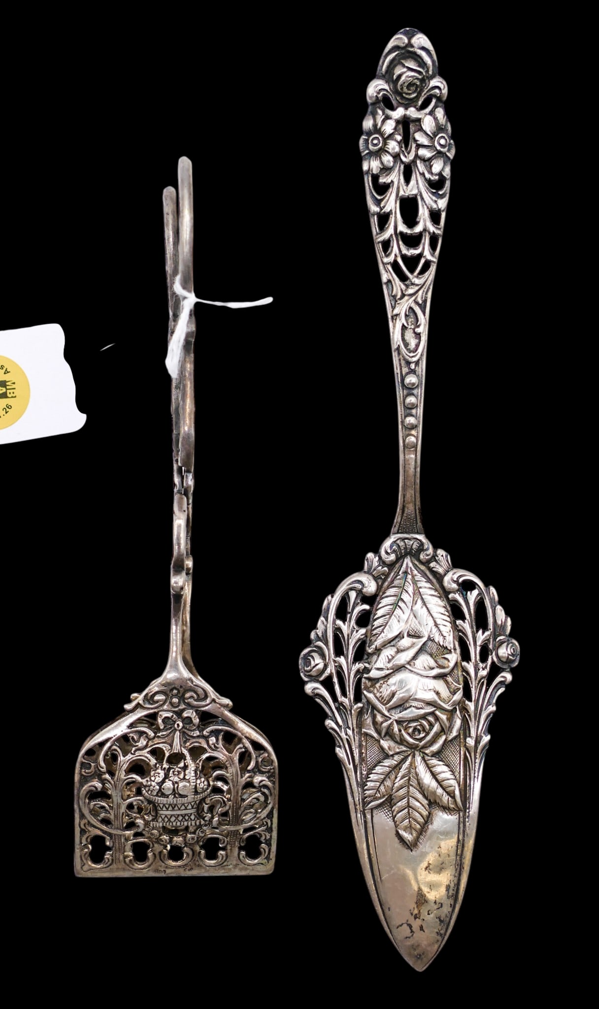 2pc Ornate German 800 Silver Pierced Serving Pieces: 2pc Ornate German 800 Silver Pierced Serving Pieces 6.5" to 9". Includes a floral pie server and pair of tongs. Hallmarked on edges. Overall excellent condition. They weigh 113 grams total.