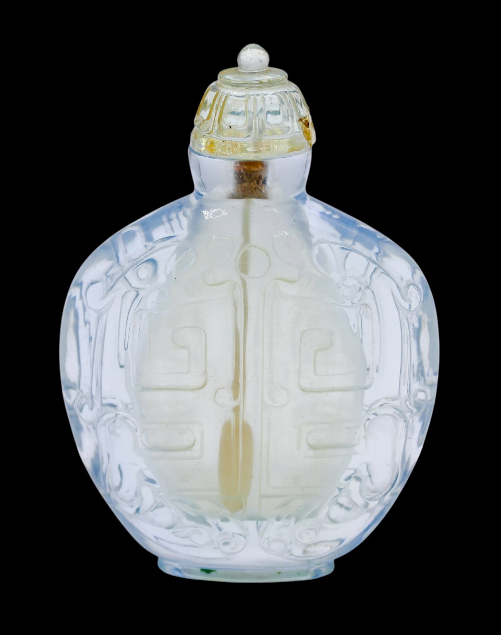 Old Chinese Carved Rock Crystal Large Snuff Bottle: Old Chinese Carved Rock Crystal Large Snuff Bottle 3.5"x2.5". Relief carved with opposing archaic chilong motifs. Stopper has repaired chips on left and ride sides. Overall excellent condition. 19th