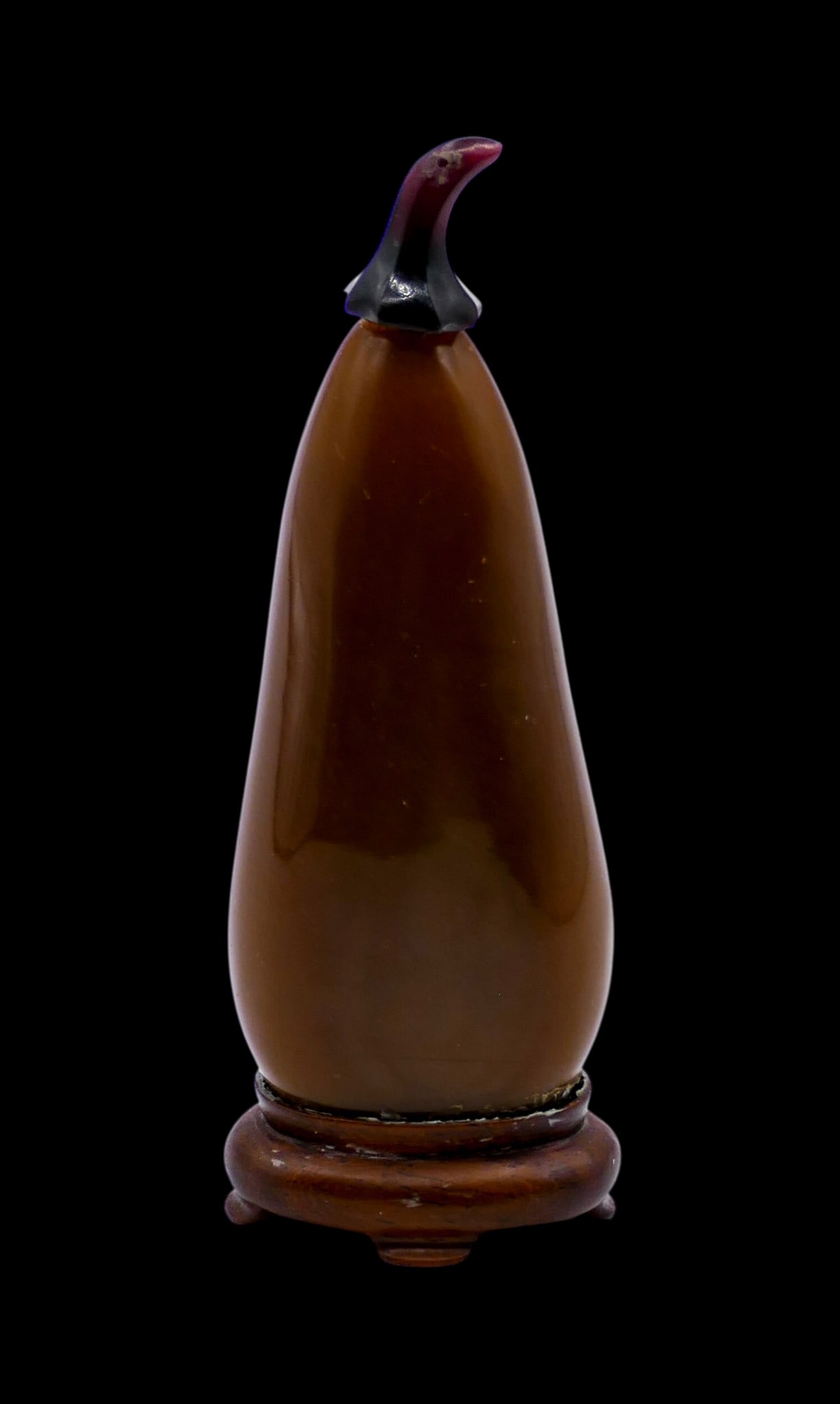 Old Chinese Brown Peking Glass Melon Snuff Bottle on Stand: Old Chinese Brown Peking Glass Melon Snuff Bottle on Stand 3.5". Slender brown form with carved amethyst figural stopper. Fitted rosewood stand. Well-hollowed form. Excellent condition. 19th century, 