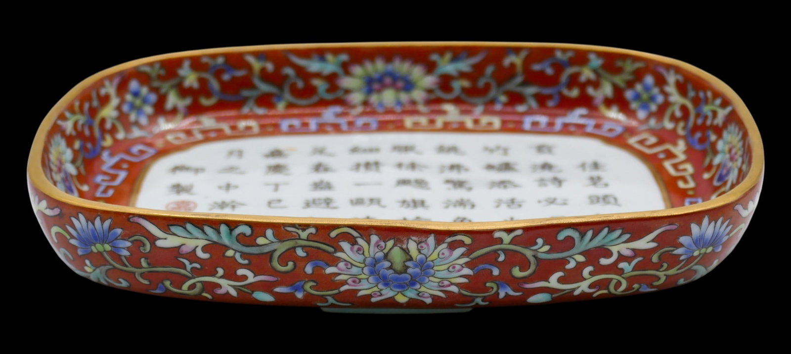 Fine Chinese Coral Ground Porcelain Calligraphy Dish: Fine Chinese Coral Ground Porcelain Calligraphy Dish 4.75"x6.25". Gilt decorated with polychrome scrolling lotus flower border. Central calligraphy with gilt Jiaqing dynasty mark. Excellent