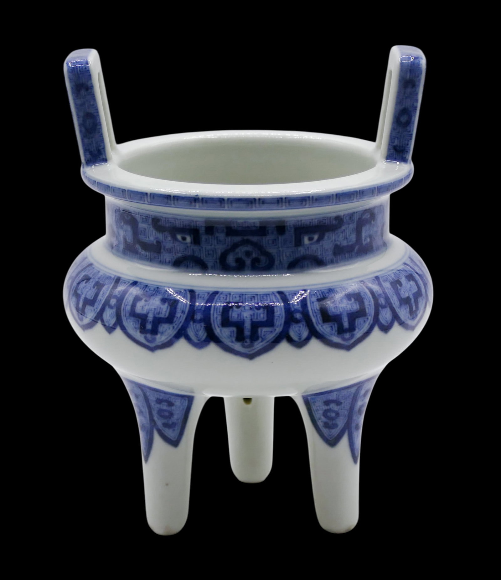 Chinese Blue and White Porcelian Archaic Tripod Censer: Chinese Blue and White Porcelian Archaic Handled Tripod Censer 6"x4.75". Blue underglaze taotie mask archic motifs. Unmarked. Excellent condition, examined under blacklight.