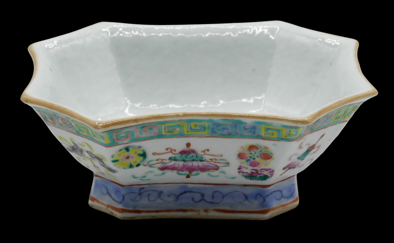 Chinese Tongzhi Buddhist Objects Porcelain Bowl: Chinese Tongzhi Buddhist Objects Porcelain Bowl 5.25"x6.25". Famille rose polychrome enameling with buddhist object motifs. Red stamped Tongzhi mark and of the period. A few tiny glaze flakes to top