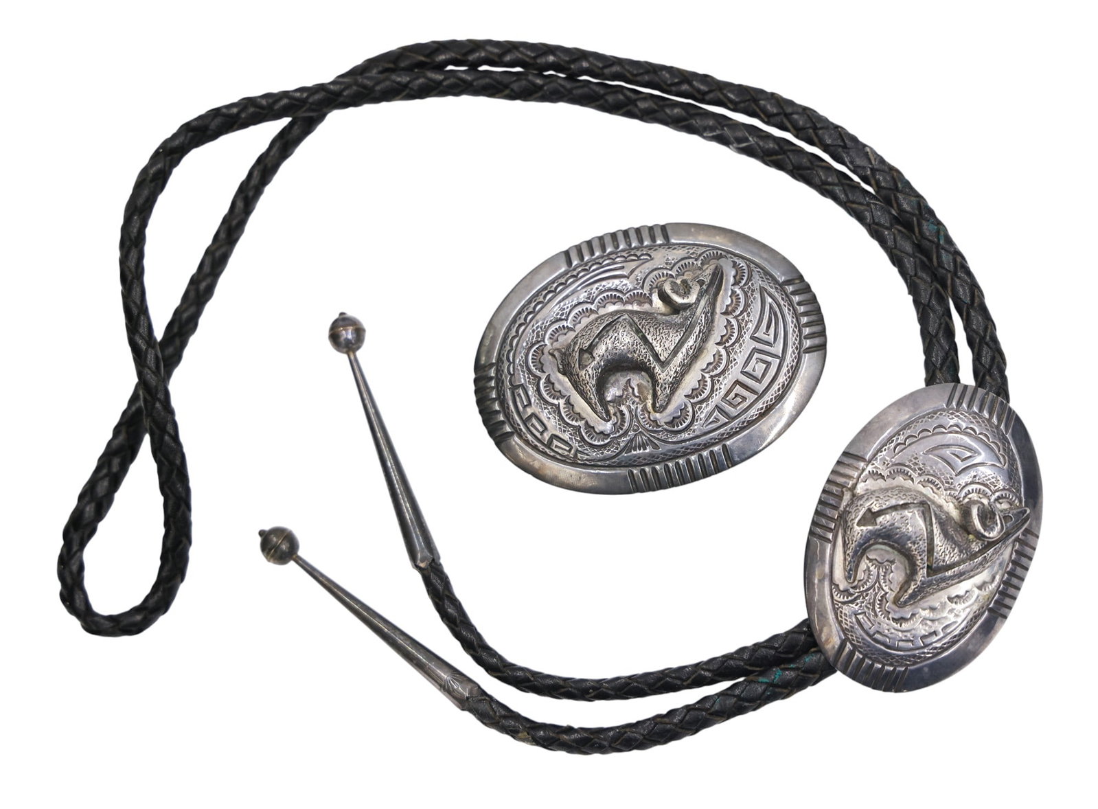 2pc Old Harvey Chavarria Santa Clara Sterling Bolo Tie and Buckle: 2pc Old Harvey Chavarria Santa Clara Sterling Bolo Tie and Buckle 2.5" to 3". Includes a relief bloodline deer motif. Signed with his mark on verso. Set weighs 108 grams total. Excellent condition.