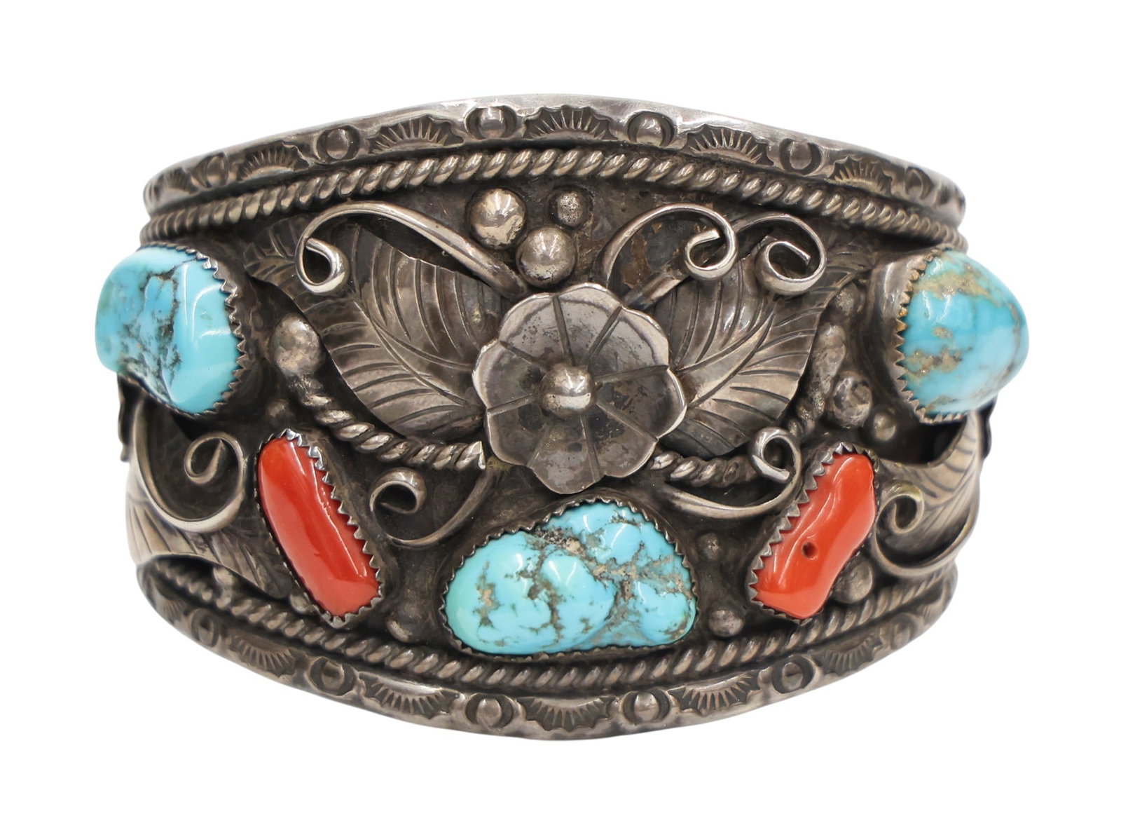 Old Navajo Sterling Turquoise and Red Coral Cuff Bracelet: Old Navajo Sterling Turquoise and Red Coral Cuff Bracelet Fits 7" Wrist. Large cuff measures 2" thick. Illegibly signed "BK DYa or DGa". Natural stones measure 14-19mm. It weighs 112 grams. Overall