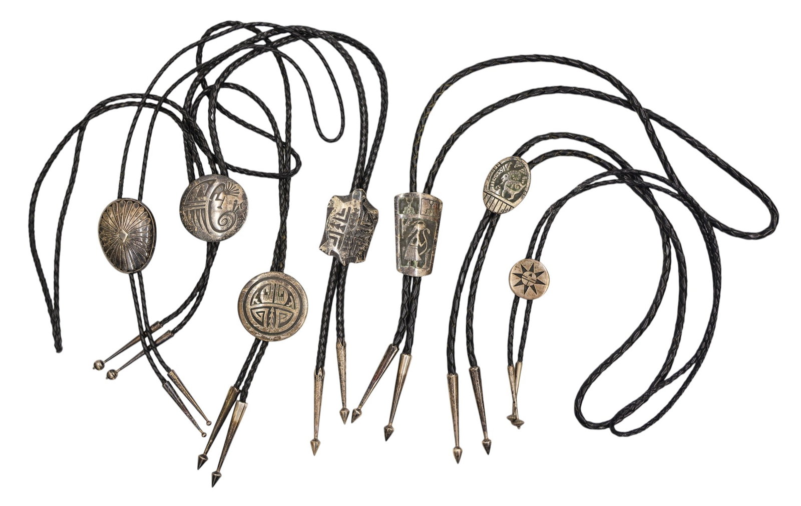7pc Navajo and Hopi Assorted Sterling Bolo Ties: 7pc Navajo and Hopi Assorted Sterling Bolo Ties 1.25" to 2.5". Some are signed with ciphers and one is Lomayestewa. Group weighs 314 grams total. Overall excellent condition.