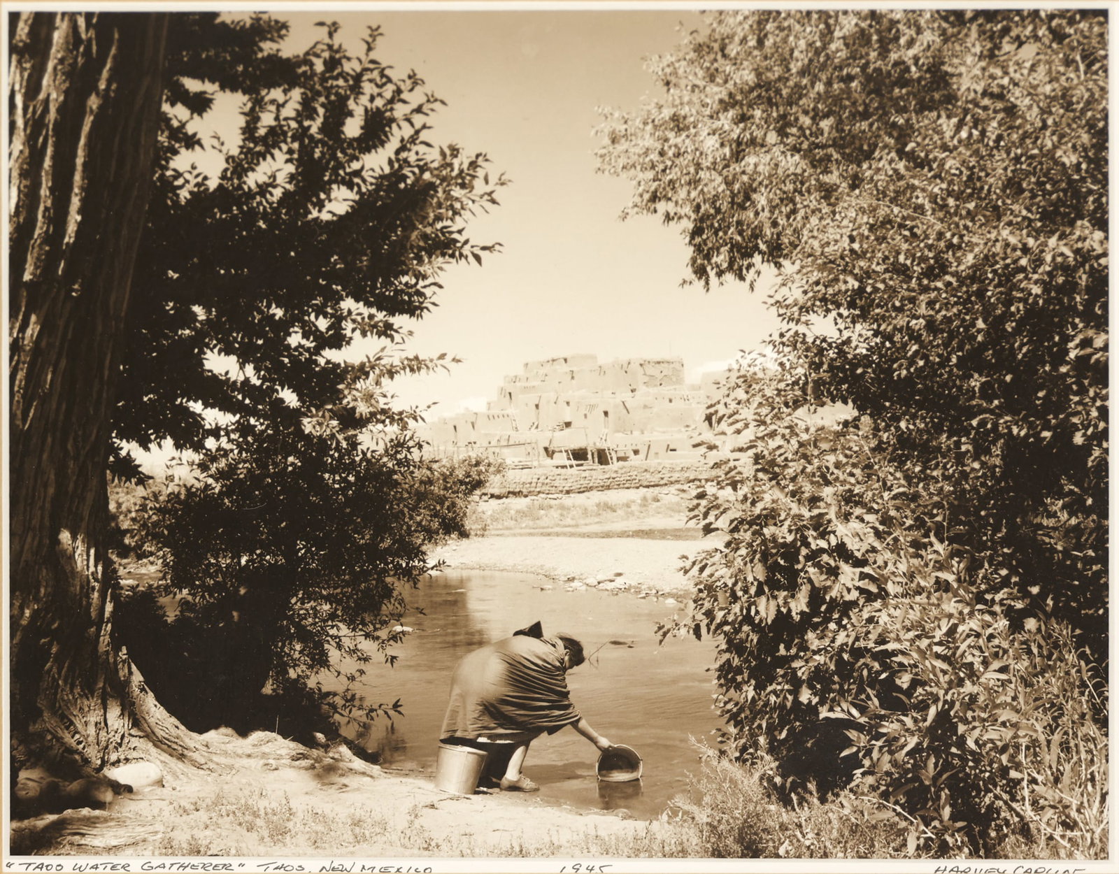 Harvey Caplin "Taos Water Gatherer" 1945 Gelatin Silver Print: Harvey Caplin (1915-1984 New Mexico) "Taos Water Gatherer" 1945 Gelatin Silver Print 8"x10" Image. Signed and titled in pencil on matting. Framed 15.5"x17.5". Excellent condition. Not examined