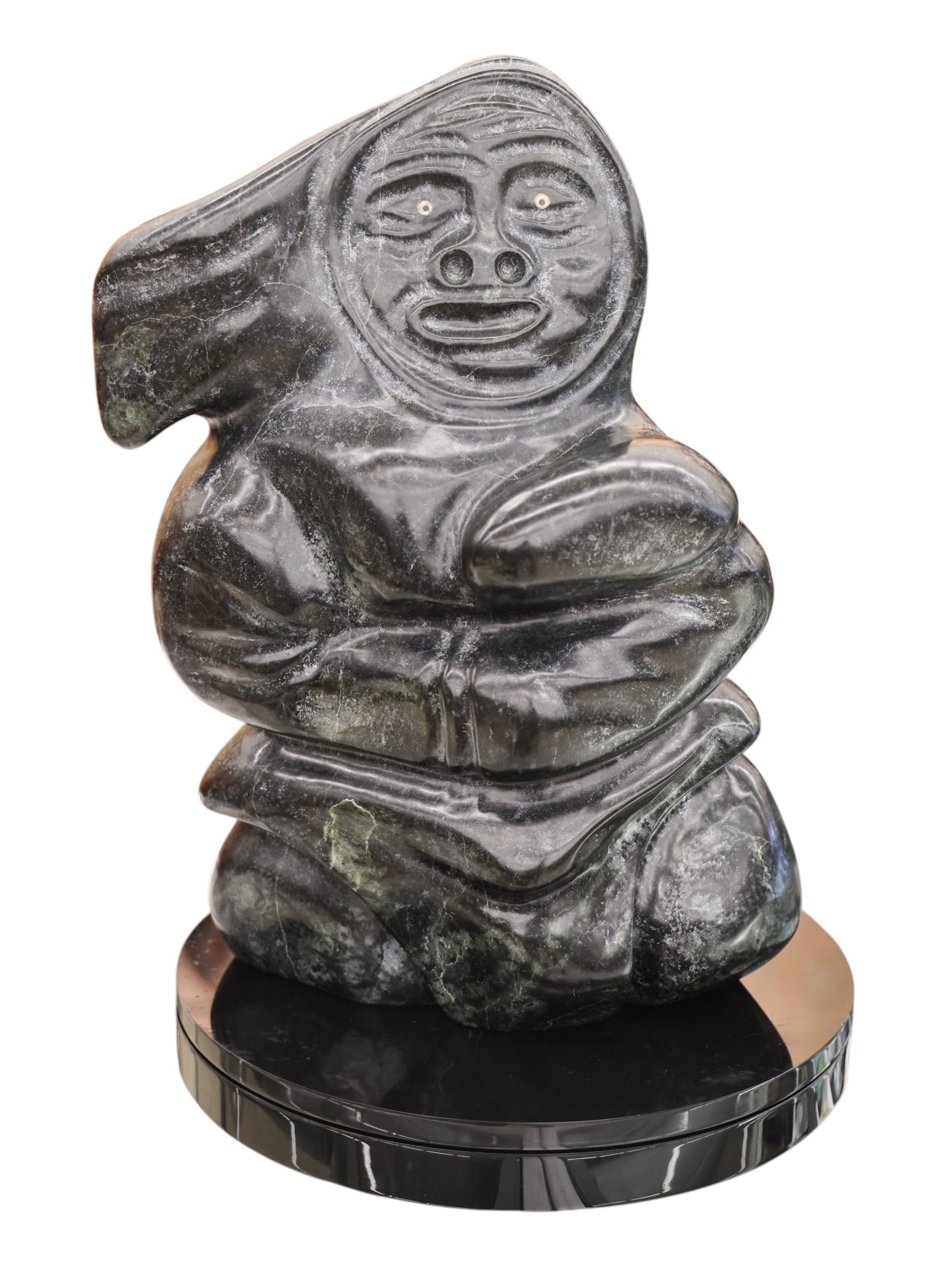 Abe Ukuqtunnuaq "Inuit Woman" Large Stone Sculpture: Abe Ukuqtunnuaq (b.1944 Inuit) "Inuit Woman" Large Stone Sculpture 15"x11". Signed on underside. Comes on black rotating acrylic platform 12". Excellent condition. It weighs 53 pounds.