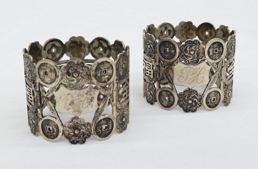 Pair of Chinese Export Sterling Coin & Character Napkin: Pair of Chinese Export Sterling Coin & Character Napkin Rings 1.25'' Thick. 19th Century. Weighing 2 troy ounces. Estate of R.V. Hill.