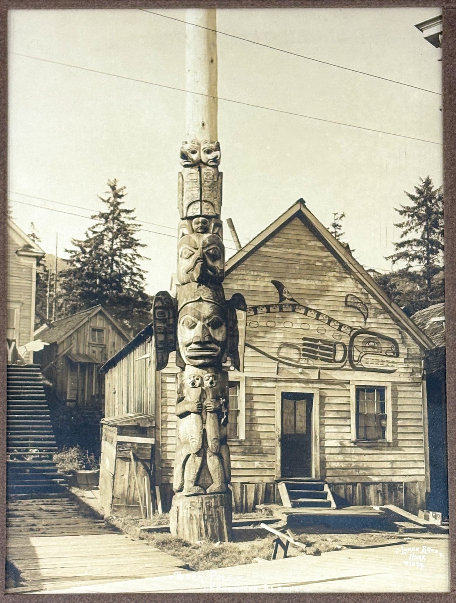Lomen Bros. "Totem Pole - Ketchikan Alaska" Photograph: Lomen Bros. "Totem Pole - Ketchikan Alaska" Photograph 9"x6.75" Image 15.75"x13.75" Framed. Signed lower right and numbered 1094. Excellent condition, not examined outside of framing.