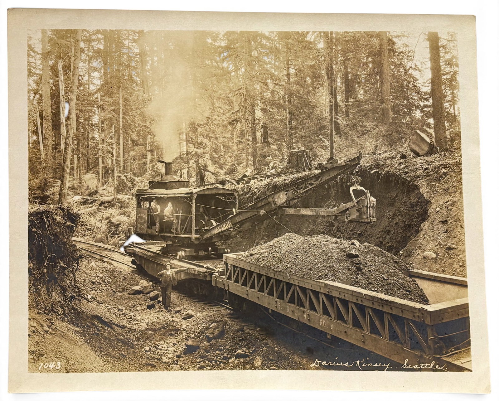 Darius Kinsey "Machinery" Photograph in Portfolio: Darius Kinsey (1869-1945 Washington) "Machinery" Photograph in Portfolio 8"x10.25" Sheet. Signed lower right and numbered 7043. Minor foxing throughout.