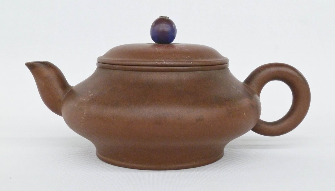 Antique Chinese Yixing Clay Teapot with Applied Clay: Antique Chinese Yixing Clay Teapot with Applied Peking Glass Painted Finial 4.5''x8.5''. Four character impressed seal mark on bottom. Red export stamp on top of lid. Chips to inside rim of lid.