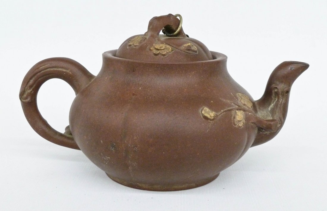 Chinese Floral Yixing Clay Teapot with Gold Painted: Chinese Floral Yixing Clay Teapot with Gold Painted Blossoming Flowers 4.25''x7.5''. Figural branch handle and spout. Chips to inside rim of lid. No mark.