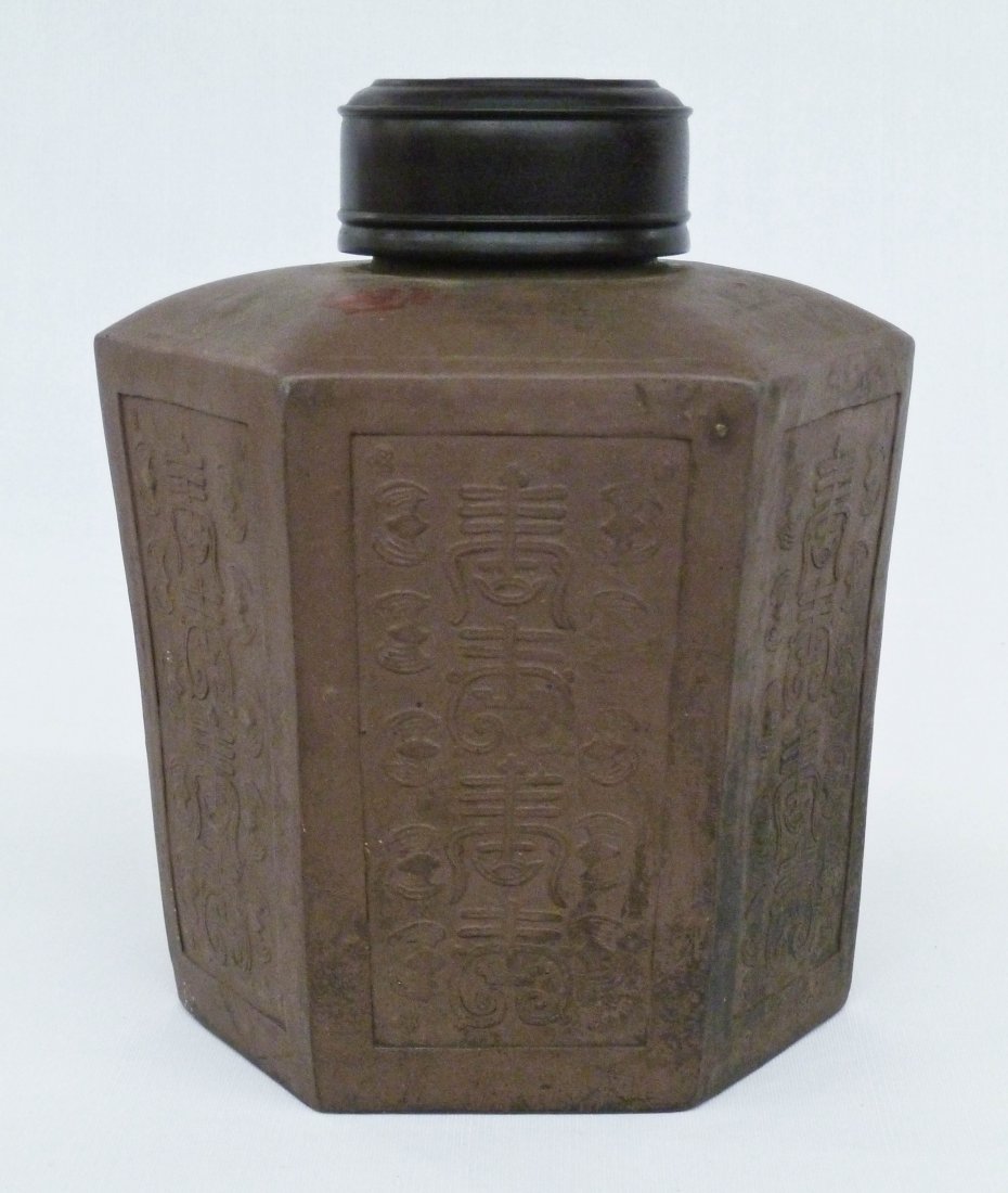 Antique Chinese Yixing Clay Large Tea Caddy: Antique Chinese Yixing Clay Large Tea Caddy 8.5''x6.5''. Polygon six sided shape, each panel having an impressed four character and bat repeating design. Replaced wooden lid. Red export stamp on top e