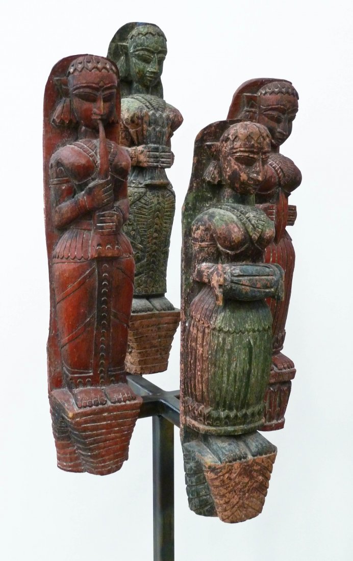 Set (4) Indonesian Carved Deity Wood Figures on Custom: Set (4) Indonesian Carved Deity Wood Figures on Custom Made Steel Stand 54.5''x17.5''x15.5''. Each is hand carved and painted and measures between 23''-25'' tall x 4''-5'' wide. Displays as a standing