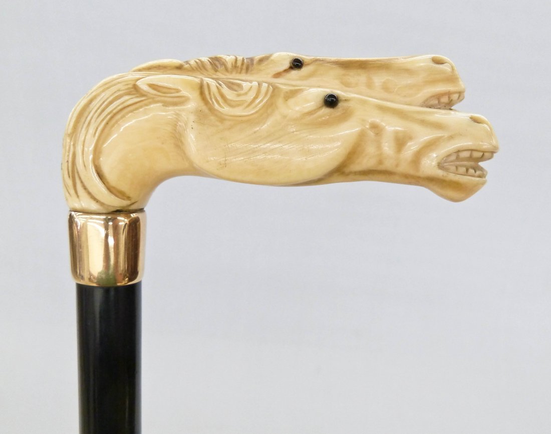 Antique Double Horse Head Carved Ivory Handle Cane 35'': Antique Double Horse Head Carved Ivory Handle Cane 35'' Depicts two galloping horses with black glass inset eyes 4.5''x1.5''. Gold mount is monogrammed ''AP'' and likely 14k gold. Some natural age cra