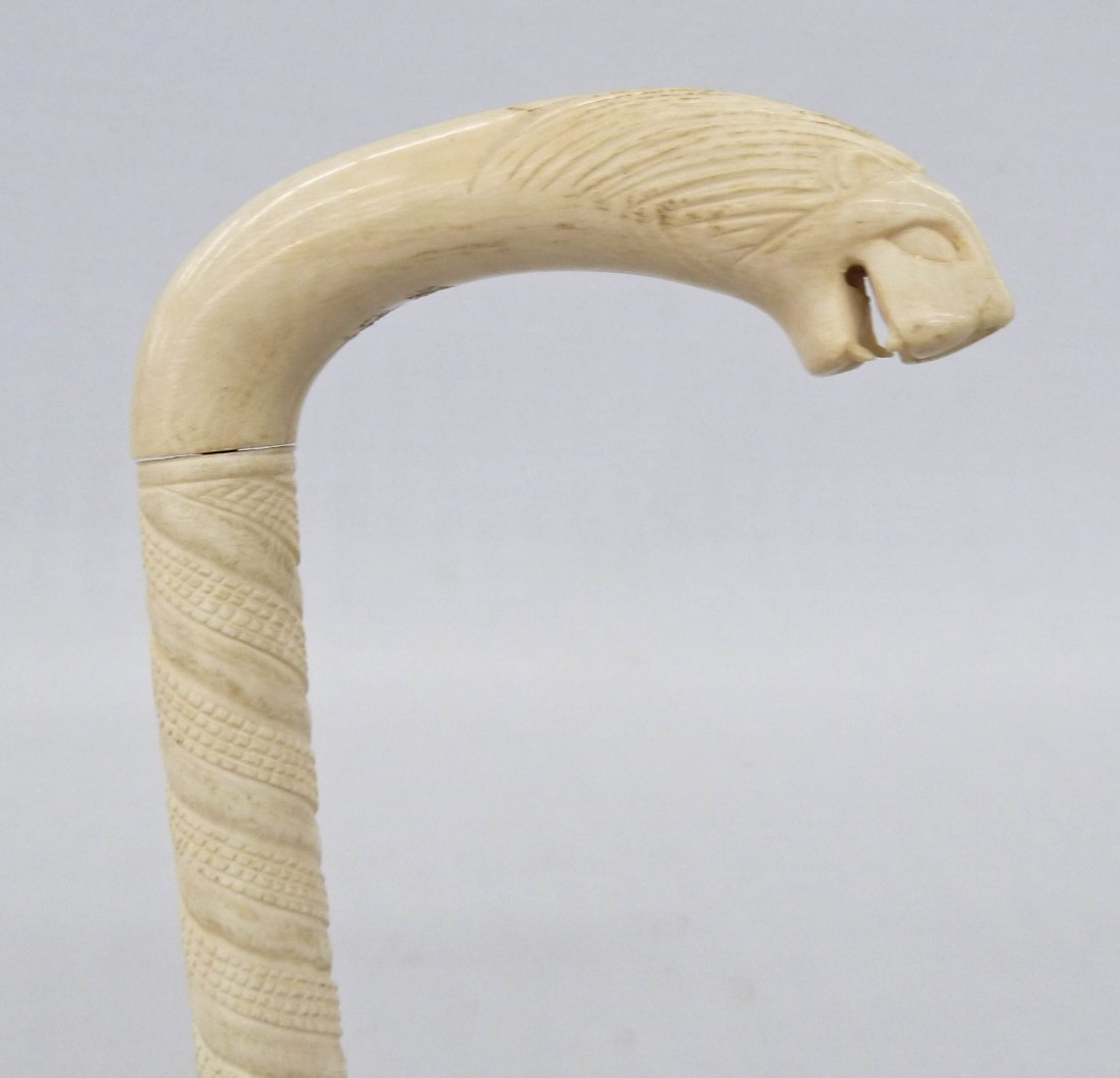 African Carved Solid Ivory Lion Head Cane 37''x4.75''.: African Carved Solid Ivory Lion Head Cane 37''x4.75''. Seven pieces of assembled solid ivory with stylized carved lion head. Some natural age cracking.