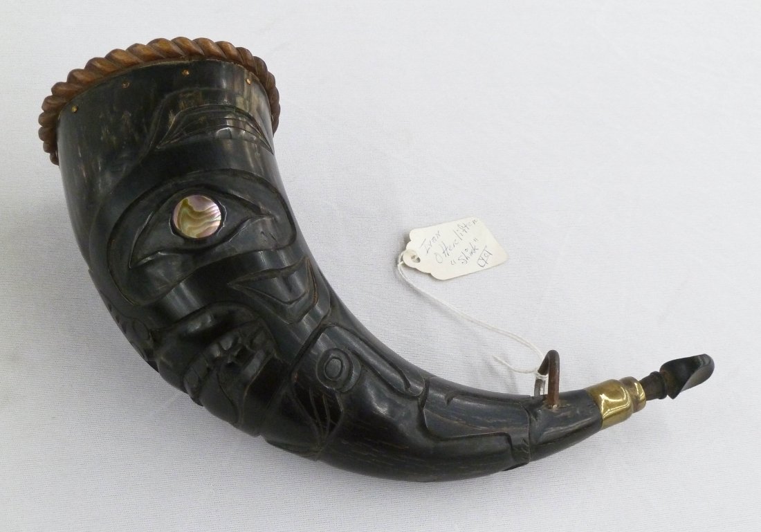 Vintage Cyot Ivan Otterflifter ''Shirk'' Carved: Vintage Cyot Ivan Otterflifter ''Shirk'' Carved Northwest Coast Indian Native Powder Horn 10.5''x3''x3.5''. Mother of pearl inlaid eyes with Tlingit u-form bear design. Signed and titled on hang tag.