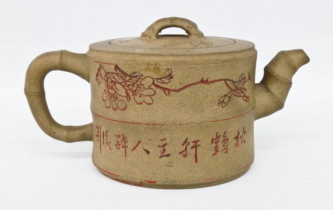 Antique Chinese Buff Colored Yixing Clay Bamboo Shape: Antique Chinese Buff Colored Yixing Clay Bamboo Shape Teapot 3.5''x7''. It has carved and painted calligraphy & blossoming flowers on exterior. Signed with impressed seal on bottom. Very slight chip u