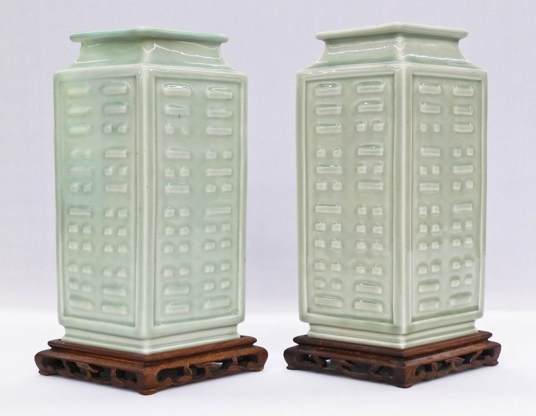 Pair Chinese Celadon Buddhist Trigram Porcelain Vases: Pair Chinese Celadon Buddhist Trigram Porcelain Vases 11.75''x7''. Each comes with a fitted carved stand. Both have blue underglaze Yongzheng seal marks. One has large professional repair at top. 19th